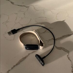 Fitbit Tracker with Tan Strap and Black Display